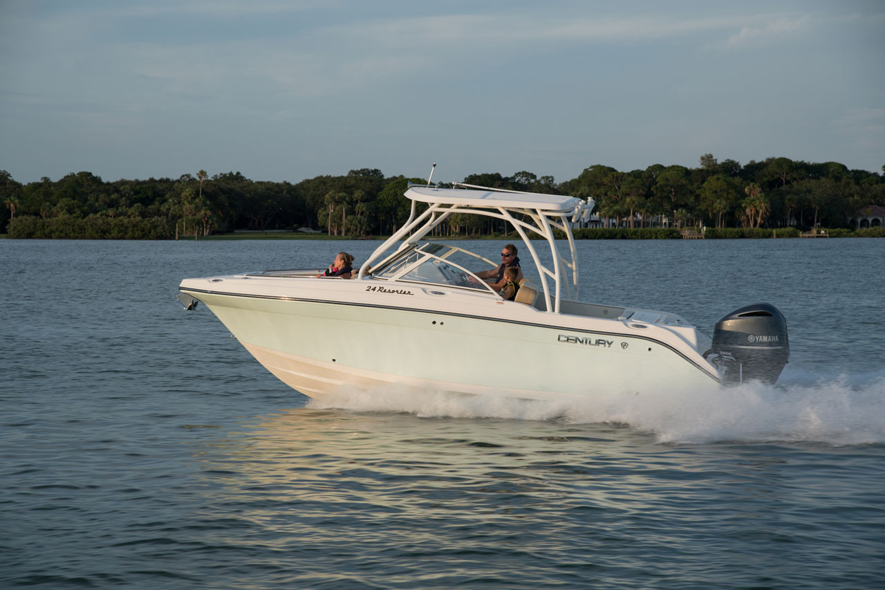 dual console boat cruising on the water with family of 4 on board