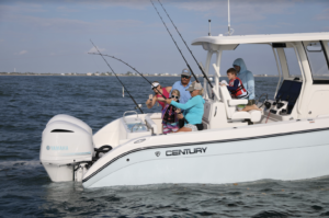 family fishing on the back of a center console boat